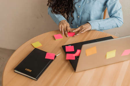 Young woman unrecognizable conducts online brainstorming for new brand concept.の写真素材