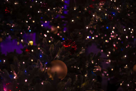 Christmas tree decorated with balls garlands, close-up photo for backgroundの写真素材