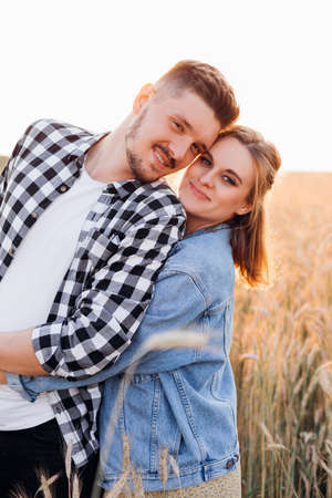 Portrait of young happy couple expecting child. Pregnancy and care. The miracle of new life. Happiness and tenderness. Care and attention. Love and hope. Healthy lifestyle. Walking in nature.の写真素材