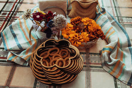 Drying bagels in an authentic carved wooden box on a tablecloth, an authentic lifestyle photo in neutral colors, composition. High quality photoの写真素材