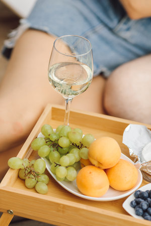 Outdoor recreation with festively served table with wine and fruit. Romantic date. Recreation and travel. Beautiful summer evenings. Tourism and entertainment. Service at the hotel. Lifestyle.の写真素材