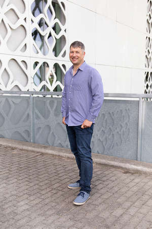 Portrait of man in shirt on background of an urban landscape. Lonely man. Acquaintance on Internet....