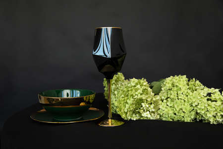 Beautiful Hydrangea bouquet on black background. Floristry wedding background, Black gold green color Luxury table set for Wedding reception, composition with wine glassの写真素材