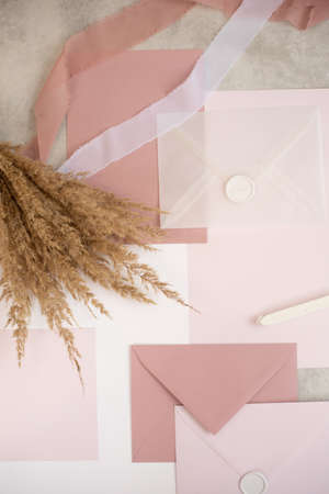 Vertical photo peach mock up composition paper envelopes, seal wax, ribbons, hand craft jobbing....