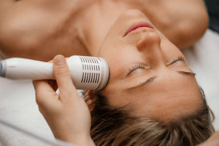 Woman relax beauty therapy spa salon. Attachments device Hydra Facial skin care machine. Anti aging wrinkle. Close upの写真素材