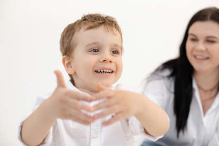 Portrait of smiling little child boy, having fun together with mother, talking. First communicating with world. Close upの写真素材