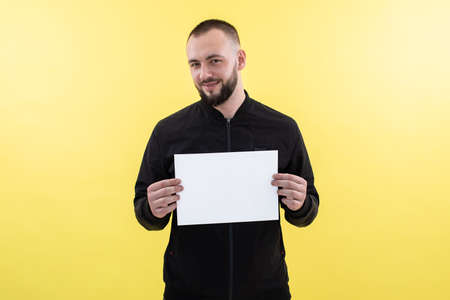 Smiling businessman with beard stand with white empty blank sheet paper. Achievement career wealth...