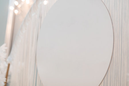 White round part of photo zone decorated by lights, strings. Celebration, wedding, birthday, decoration. Soft focus.の写真素材