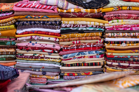 Huge selection of multicolored scarves, pareos, shawls, fabric cuts with various patterns lies of trading place .の写真素材