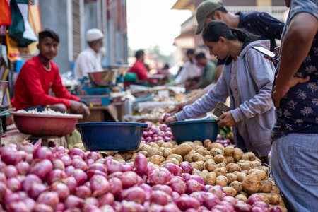Goa, India, February 2023. Close-up of stalls full of fresh potatoes, red onions at Indian outdoor local street market.のeditorial素材