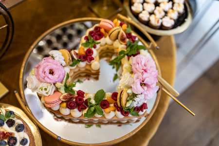 Heart-shaped cake is luxuriously decorated with berries, mint leaves, fruits, meringues, and cream .の写真素材