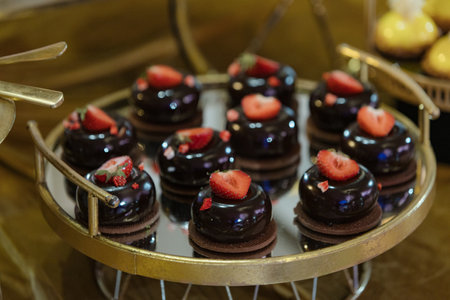 Candy bar, dessert sweet table, cakes are on round tray at wedding event, party, holiday. Enjoying.の写真素材
