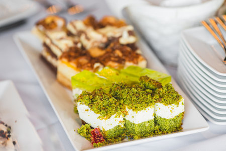 Sweet desserts with whipped cream and nuts on sweet table at wedding, party, holiday. Candy bar .の写真素材
