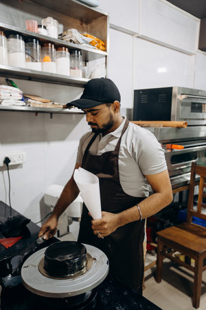 Skilled chef decorates cake in modern kitchen with precision and attention to detail
