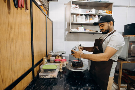 A skilled barista is busy preparing coffee in a stylish and contemporary cafe environmentの写真素材