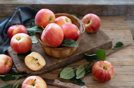 Apples with leaves on the wooden table