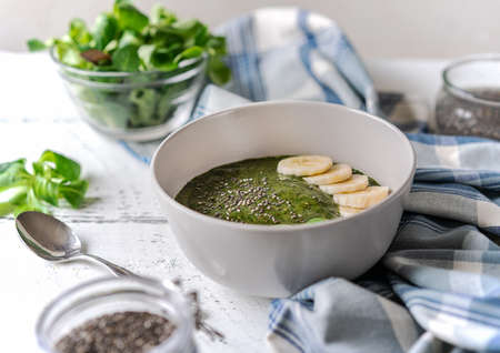 Green porridge in bawl with main ingredients: chia seeds, greensの写真素材