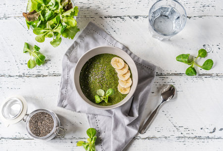 Green porridge in bawl with ingredientsの写真素材