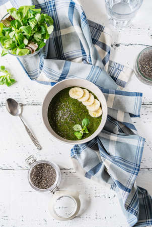 Green porridge in bawl with main ingredients: chia seeds, green, waterの写真素材