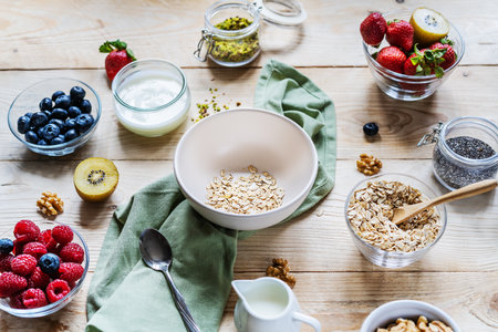 Healthy breakfast concept with oat flakes, fruits, yogurt, nuts, berries, chia seedsの写真素材