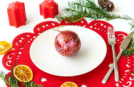 Christmas ball on the plate with decoration
