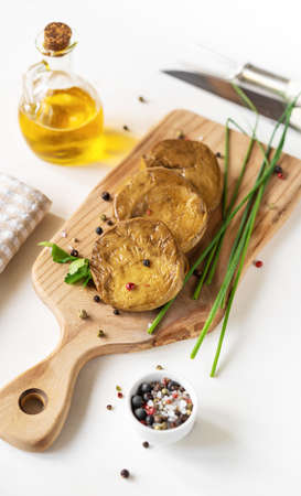 Seitan stakes with spices, olive oil, fresh leek on cutting boardの写真素材