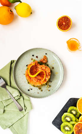Delicious and unusual tartare salmon with kiwi and orange sauceの写真素材