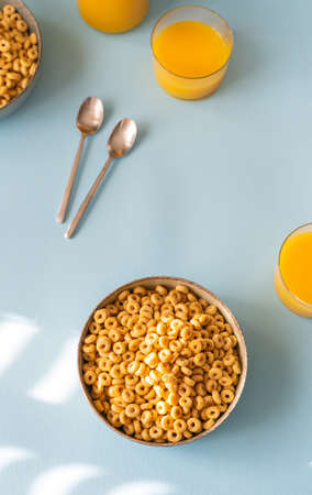 Breakfast concept with cold cereals and orange juice on blue backgroundの写真素材
