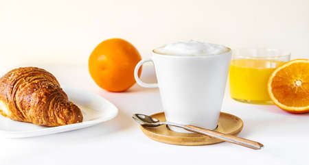 Breakfast concept with coffee, orange juice and croissant