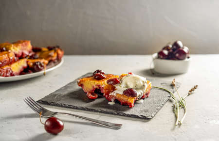 Homemade sweet cherry pie or red brownie cake. One piece with ice cream on stone stand, whole cake...
