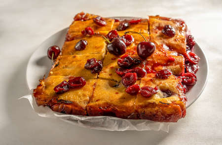 Fresh baked sweet cherry pie or red brownie cake on plate close up