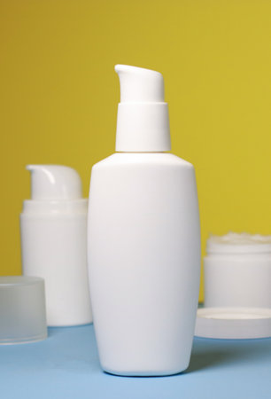 mock up of white jar of cream on a yellow background. Ready place for the label, copy spaceの写真素材