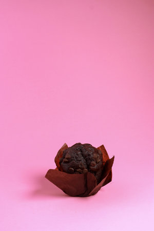 chocolate chip muffin isolated on pink backgroundの写真素材