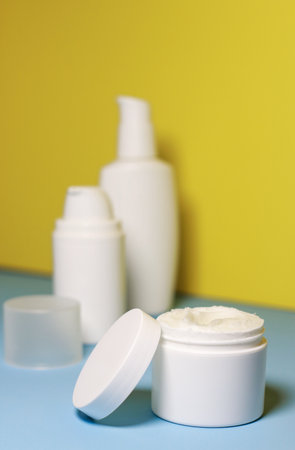 mock up of white jar of cream on a yellow background. Ready place for the label, copy spaceの写真素材