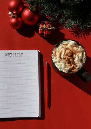 red Christmas composition with hot chocolate and note book for wish listの写真素材