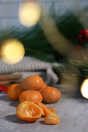 close up of a peeled mandarin, blurred background with xmas tree and lightsの写真素材