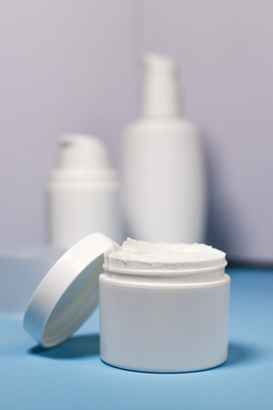 close up of mock up white jar with cream on a blue backgroundの写真素材