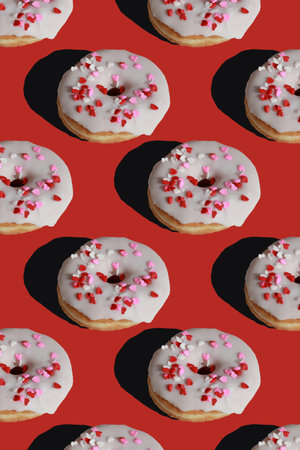 seamless pattern of donuts with sugar glaze on red backgroundの写真素材