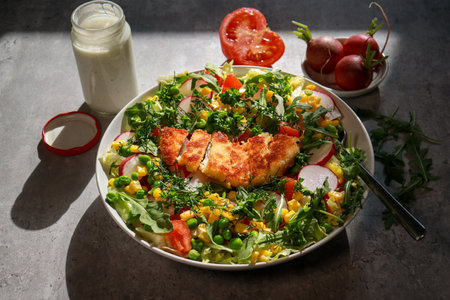 Southwest Chicken Salad on grey marble table with dressing, upper viewの写真素材