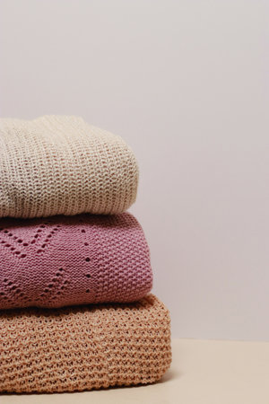 stack of folded knitwear, minimal lifestyle, capsule wardrobe, copy spaceの写真素材