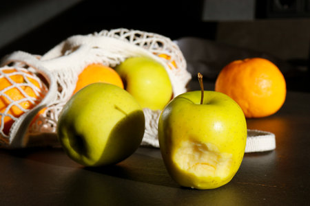 close up of fresh apples and oranges in cotton eco string bagの写真素材