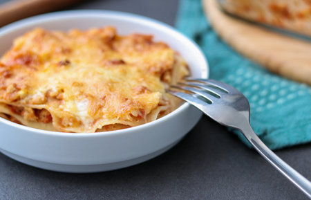 Homemade vegan Lasagne with soy meat and vegan cheese on a white plateの写真素材