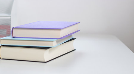 Close up mock up books stack on white table with copy space