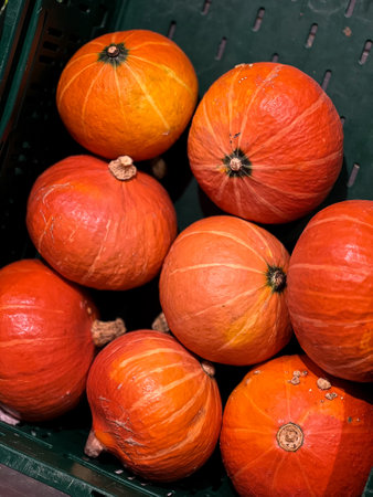 Close up of a fresh Hokkaido pumpkins in a basket at grocery store