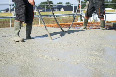 Workers filling the second floor ground with concrete, core and shell construction buildingの写真素材