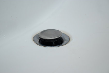 Close up of bathtub with limescale and dirty metal drain holeの写真素材