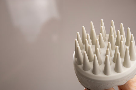 Close up of a beige scalp massager for hair growth stimulationの写真素材