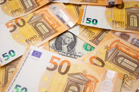 Close up of fifty euro money bills and a dollar bill in the middle backgroundの写真素材