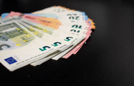 Close up of euro money bills fanned out, black backgroundの写真素材