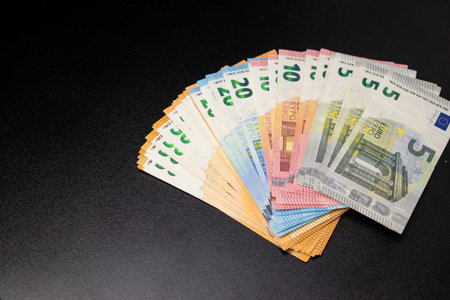 Close up of euro money bills fanned out, black backgroundの写真素材